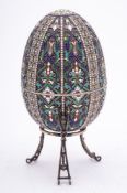 A late 20th century silver gilt and champlevé enamel Easter egg in the Imperial Russian style: