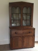A George IV mahogany and ebony inlaid Gothic secretaire bookcase:,