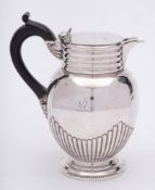 A Victorian silver hot water jug, maker Goldsmiths and Silversmiths Co Ltd, London, 1900: crested,