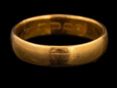 A 22 carat gold ring,: the plain polished band stamped 22 with full Birmingham hallmarks,