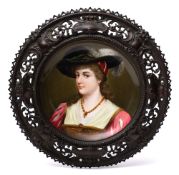 A Continental porcelain plaque in the Vienna manner: depicting a young woman wearing baroque-style