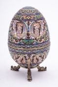 A late 20th century silver gilt and champlevé enamel Easter egg in the Imperial Russian style: