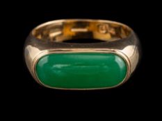 A green hardstone ring:, the oblong polished green hardstone, in a collet setting, stamped 585,