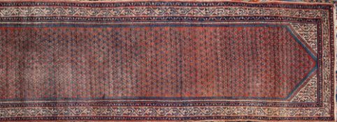 A Caucasian runner:, the brick red field with a repeated boteh design,