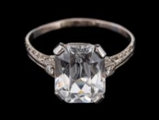 A white spinel and diamond ring,: the central rectangular cut white spinel in a four claw setting,