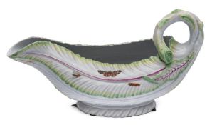 A First Period Worcester polychrome sauceboat: of cos lettuce leaf form with stalk handle,