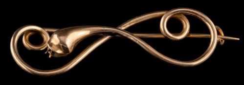 A gold coloured snake brooch,: designed as a twisting abstract snake, 5.5cm wide.