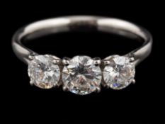 A platinum diamond three stone ring,: the central brilliant cut diamond estimated to weigh 0.