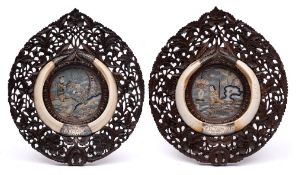 A pair of 19th century carved hardwood frames: centred with Chinese embroidered panels and enclosed