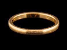 A 22 carat gold ring,: the plain polished band, stamped 22 with full Birmingham hallmarks for 1932,