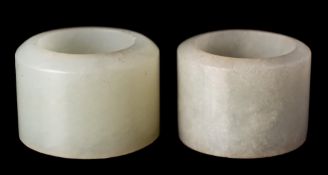 Two Chinese pale celadon jade archers' rings: 2.7cm and 3cm diameter.
