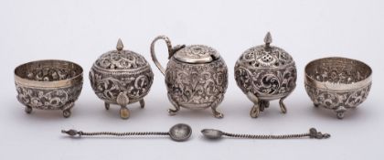 An Indian five piece white metal cruet: of circular form,