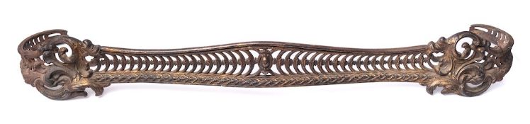 A Victorian gilt cast iron fender in rococo revival style: of serpentine outline,