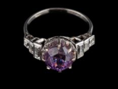 A platinum purple sapphire and diamond ring,: the circular cut purple sapphire stated to weigh 5.