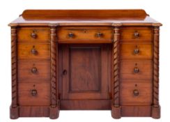 A Victorian mahogany kneehole desk:, of breakfront outline,