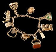 A 9 carat gold charm bracelet,: the curb link chain suspending various charms, including: a tiger,