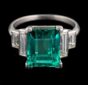 An emerald and diamond ring,: the rectangular cut emerald, stated to weigh 4.