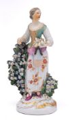 A Derby figure of a girl emblematic of Summer: holding a sheaf of corn and a flask in her left hand,