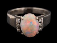 An opal and diamond ring,: the oval cabochon opal claw set between eight cut diamond set shoulders,