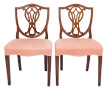 A pair of George III mahogany dining chairs:, in the Hepplewhite taste,