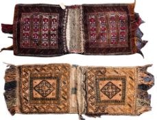 An Afghan Belouch saddle bag:, the shaded brick red fields with lozenge panels,