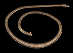 A 9 carat gold necklace,: the three colour gold necklace composed of textured panels to the centre,