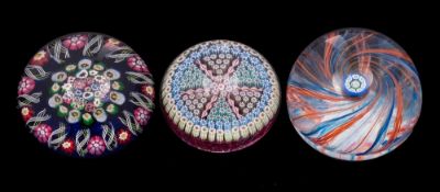 Three Scottish paperweights: comprising a close pack millefiori example with multi-coloured canes