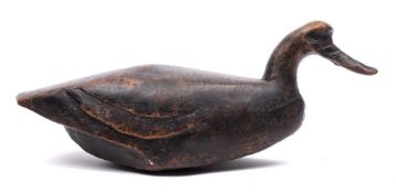 A carved hard wood goose decoy: 54cm long.