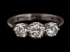 A diamond three stone ring,: set with three brilliant cut diamonds, approximately 1.