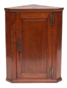 A George III oak hanging corner cupboard, last quarter 18th century,