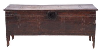 A 17th Century oak rectangular coffer:, of plank construction with a channel moulded hinged top,