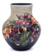 A Moorcroft pottery vase: of oviform with raised neck tubelined in the Spring Flowers pattern in