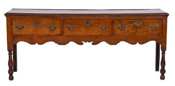 An 18th Century oak rectangular dresser base:, the top with a moulded edge,