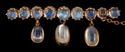A moonstone brooch,: set with a row of circular cabochon moonstones, in claw settings,