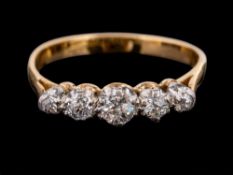 An 18 carat gold and diamond ring,: set with five old brilliant cut diamonds, approximately 0.