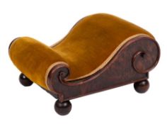 A Victorian yew-wood footstool of scroll outline:, upholstered in dralon fabric on ball-shaped feet,