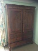 A gentleman's 19th Century mahogany wardrobe:, with a moulded dentil cornice,