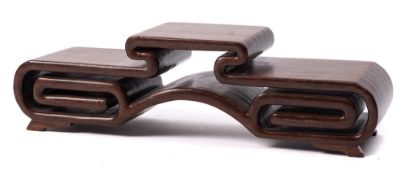 A Chinese hardwood tiered stand: of openwork scroll form, 28cm wide.