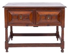 A 17th Century oak rectangular side table:, the top with a moulded edge and re-entrant corners,