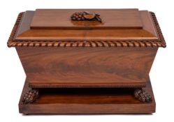 An early Victorian carved mahogany cellarette:, of sarcophagus shape,