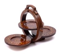 A mahogany and inlaid metamorphic three-tier cake stand: of circular form with three folding discs