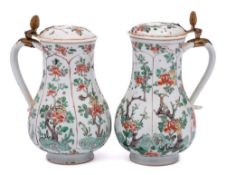 A matched pair of Chinese famille verte jugs and covers: of baluster form with Dutch gilt-metal