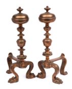 A pair of 19th century brass andirons: with knopped stem and finial on paw front feet and swept