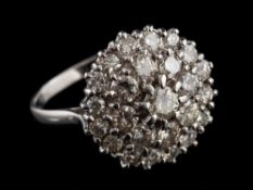 A diamond cluster ring,: the circular panel set throughout with brilliant cut diamonds,
