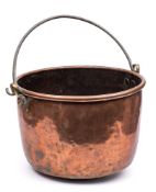 A large 19th century copper cauldron: of plain circular form with steel loop carrying handle,