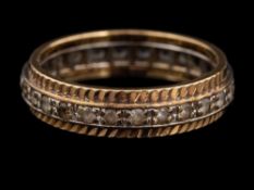 A 9 carat gold and diamond ring,: the band set with circular cut white stones,
