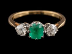An 18 carat gold emerald and diamond ring,