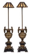 A pair of 19th century French bronze lamps: the fitting on a slender stem mounted on a baluster
