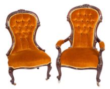 A Gentleman's Victorian carved walnut armchair and a lady's matching chair:,