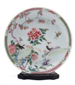 A Chinese famille rose saucer dish: painted with cranes amongst peonies and rockwork within a lotus